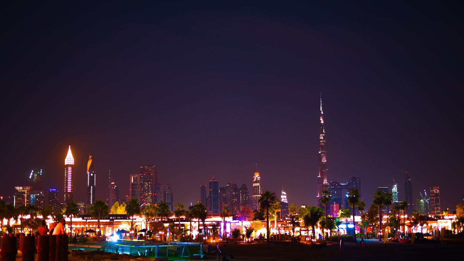 Dubai skyline at night with illuminated skyscrapers